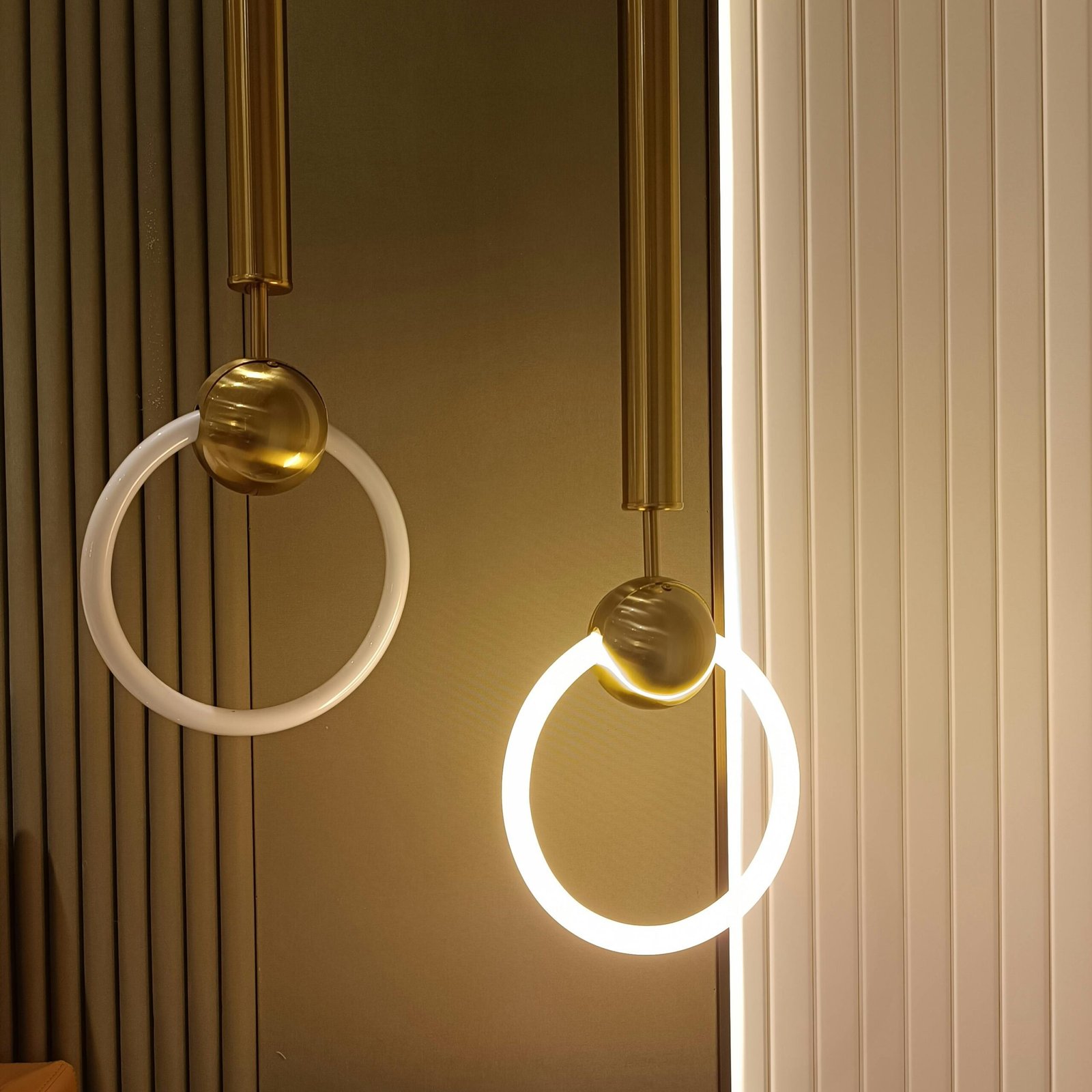 Stylish modern pendant lights with circular design in a minimalist interior.